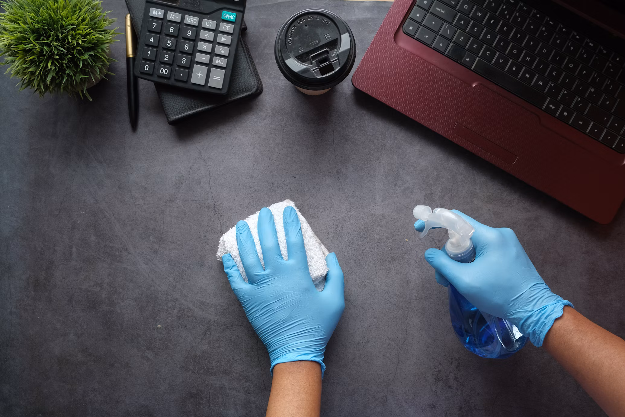 Cleaner wiping down a modern office desk